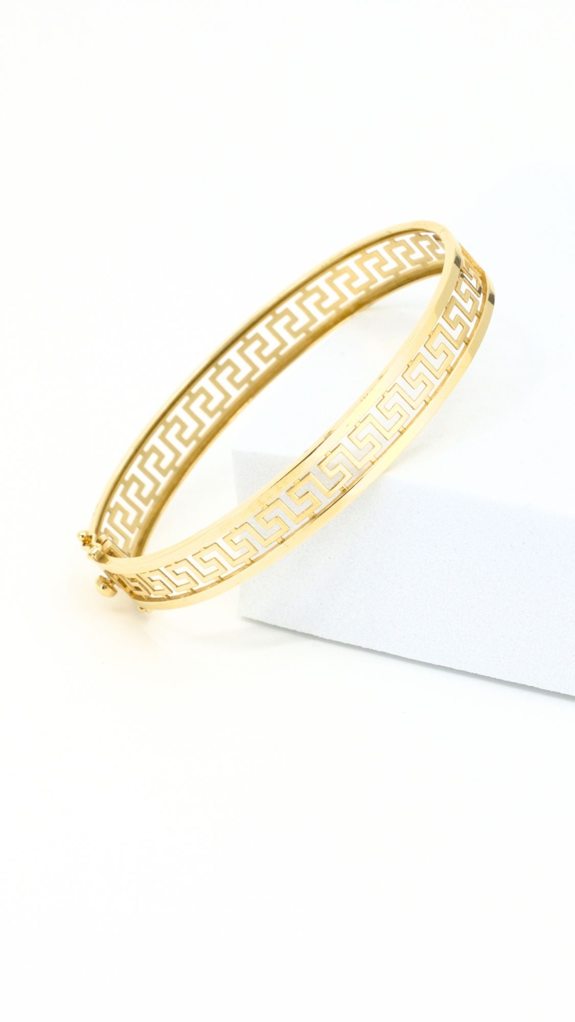 Gold bracelet with Greek meander design.